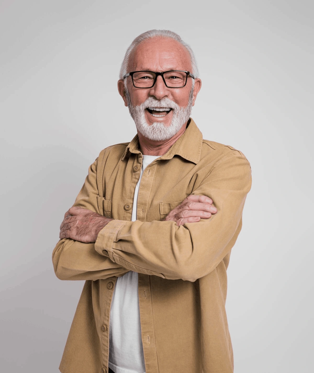 A man with glasses and beard wearing a tan shirt.